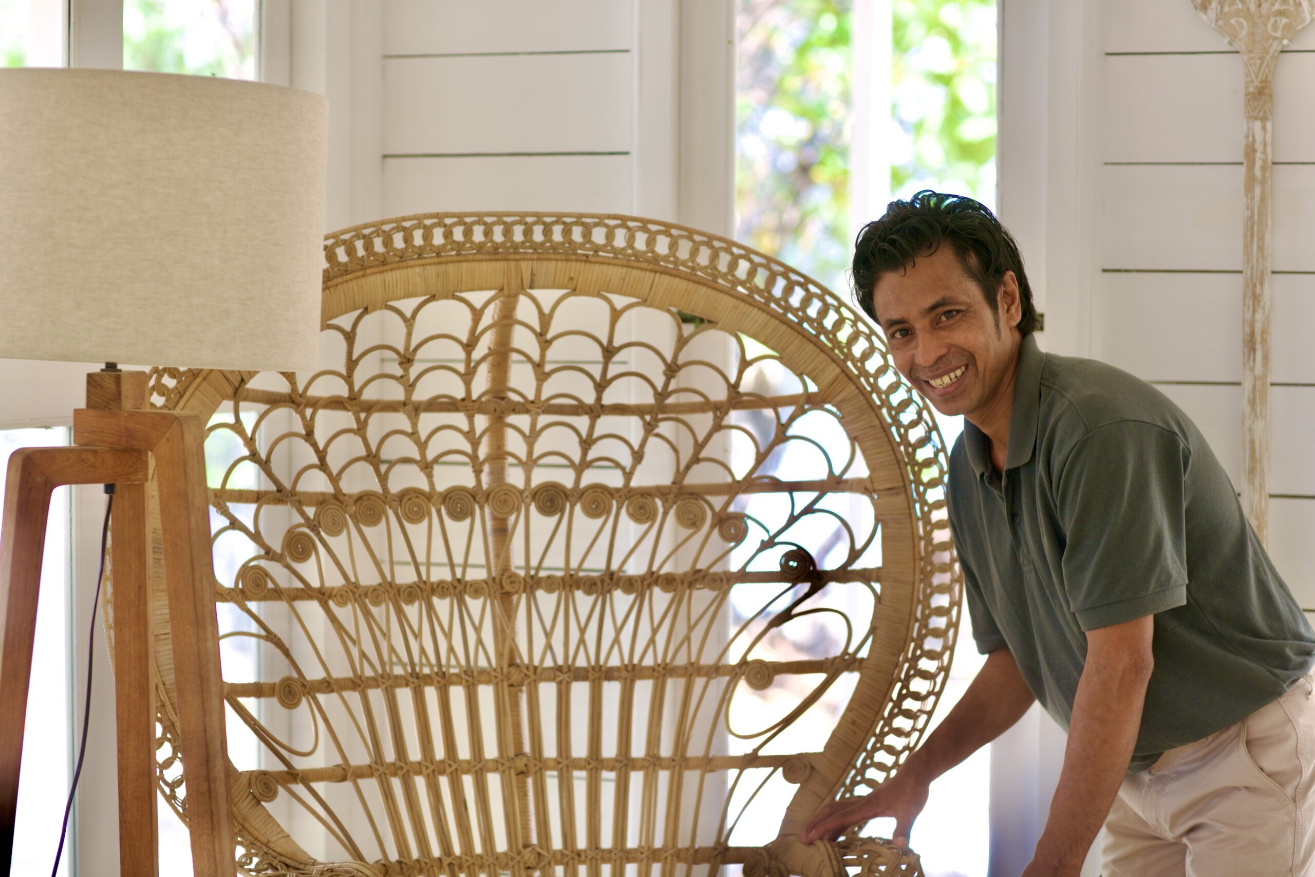 A rattan peacock chair in a bright white interior